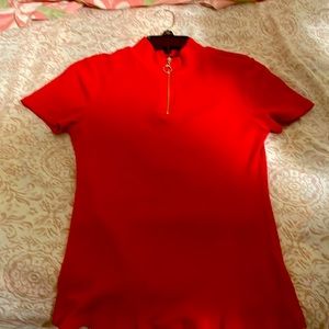 A sexy red AMBIANCE top with a golden colored zipper